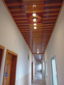 a hallway with a wooden ceiling in a building at Amsterdam Hôtel in Douala