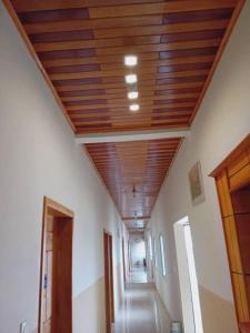 a hallway with a wooden ceiling in a building at Amsterdam Hôtel in Douala