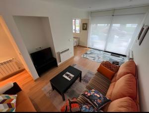 a living room with a couch and a table at Comillas 30 Primera Línea de Playa in Comillas