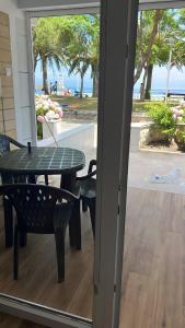 a patio with a table and chairs and a view of the ocean at Comillas 30 Primera Línea de Playa in Comillas