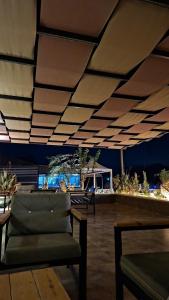 a room with a couch and a table and a ceiling at Desert Hello Camp in Wadi Rum
