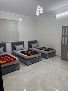 a room with three beds and a couch at اطلال الهدا Al-Hada ruins in Taif