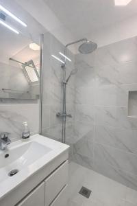 a white bathroom with a sink and a shower at Maresia's House, Madalena do Mar in Madalena do Mar +41 photos