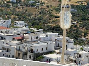 a wine glass in front of a city at Vasiliki Skyros Castle View in Skiros