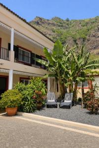 two white chairs sitting in front of a building at Maresia's House, Madalena do Mar in Madalena do Mar