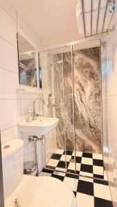 a bathroom with a toilet and a sink and a shower at Hotel Damsquare in Amsterdam +18 photos