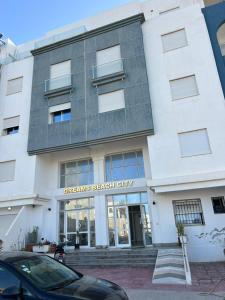 a white building with the words dreams beach city at dreams beach city in Sousse