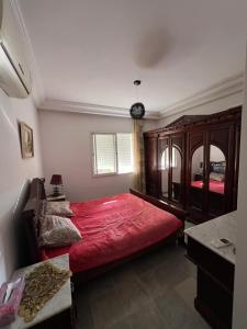 a bedroom with a large red bed and a mirror at dreams beach city in Sousse