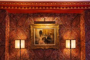 a painting on a wall in a room with two lamps at Maison Proust, Hotel & Spa La Mer in Paris