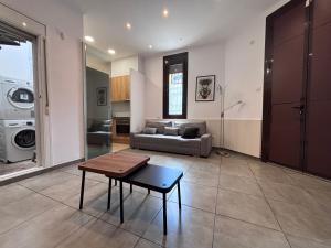 a living room with a couch and a table at Private Terrace House near Camp Nou in Hospitalet de Llobregat