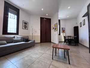 a living room with a couch and a table at Private Terrace House near Camp Nou in Hospitalet de Llobregat