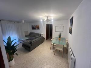 a living room with a couch and a table at Brisa de la Laguna in Chipiona
