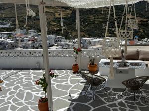 a balcony with a table and chairs and a city at Vasiliki Skyros Castle View in Skiros