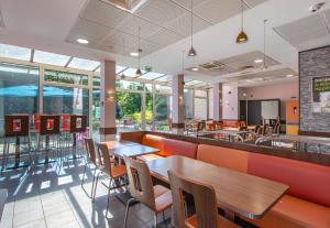 a fast food restaurant with tables and chairs at B&B HOTEL Chartres Centre Cathédrale 3 étoiles in Chartres