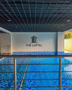 a pool of water in a building with a sign at Nyvin Haven at The Loftel in Ruaka