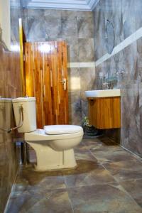 ein Badezimmer mit Toilette und Waschbecken in der Unterkunft Hôtel LEWI 2 Bouaké in Bouaké