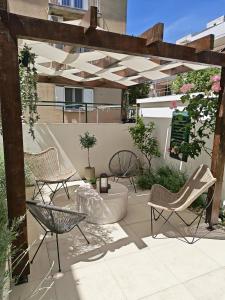 a patio with several chairs and a table at Olea Premium Rooms in Zadar