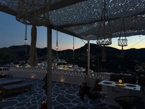 a rooftop patio with a view of a city at Vasiliki Skyros Castle View in Skiros