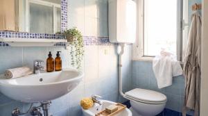 a bathroom with a sink and a toilet at B&B Hotel Villa Nora in Bellaria-Igea Marina