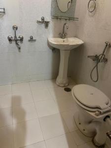 a bathroom with a toilet and a sink at Ahmed Lodge in Harganyiwan