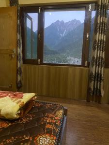 a bedroom with a window with a view of a mountain at Ahmed Lodge in Harganyiwan +9 photos