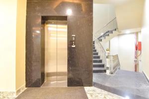 a elevator in a building with a glass door at FabHotel The Fort - Near Amber Palace in Jaipur