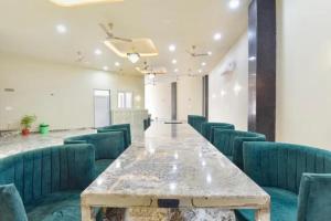 a conference room with a long table and green chairs at FabHotel The Fort - Near Amber Palace in Jaipur