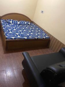 a bed in a room with a couch and a chair at Ahmed Lodge in Harganyiwan