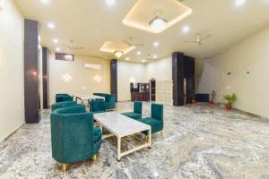 a conference room with green chairs and a table at FabHotel The Fort - Near Amber Palace in Jaipur