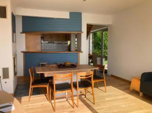 a kitchen and dining room with a table and chairs at Maison Ty Bastian, 100 M² in Saint-Michel-en-Grève