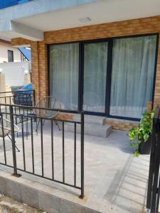 a balcony of a house with a bench and windows at Garsoniera Serena in Saturn