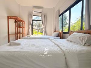 two beds in a bedroom with a large window at Villa La Forest Koh Phangan in Ko Phangan +29 photos