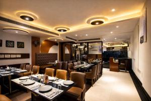 a restaurant with tables and chairs in a room at Hotel Delhi 37 by Star Group in New Delhi