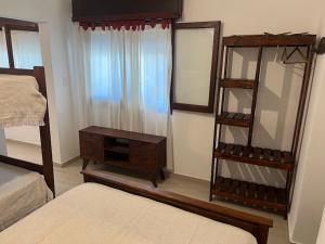 a bedroom with a mirror and a dresser and a bed at Espacio493 in Villa Gesell