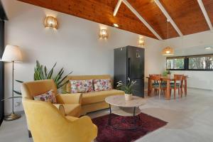 a living room with a couch and chairs and a table at Out of Africa Resort in Had Nes