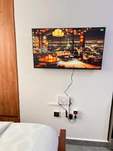 a flat screen tv hanging on a wall at Casa Stays in Kiambu