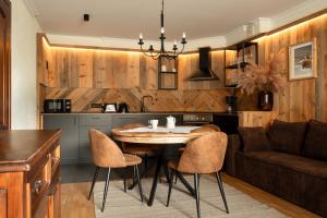 a kitchen and living room with a table and chairs at Willa Apart in Zakopane