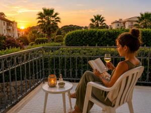 a woman sitting in a chair reading a book and drinking wine at Sorrento Life 1 in Sant'Agnello +76 photos