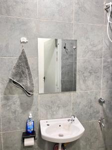 a bathroom with a sink and a mirror at Casa Stays in Kiambu +13 photos