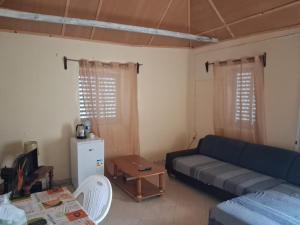 a living room with a couch and a table at Porto Calheta in Calheta +2 photos