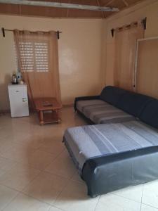 a living room with a couch and a table at Porto Calheta in Calheta