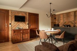 a kitchen and dining room with a table and chairs at Willa Apart in Zakopane