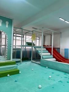 a play room with a slide at Nyvin Homes at The Loftel in Ruaka