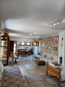 a living room with a couch and a stone wall at Egina Home in Egina