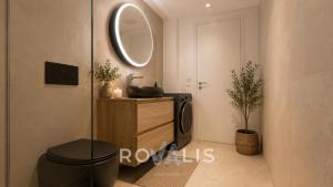 a bathroom with a toilet and a sink and a mirror at Panorama Apartment Ried-Brig in Ried-Brig