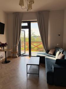 a living room with a couch and a table at Apartamenty u Gruzina in Ruda