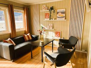 a living room with a couch and two chairs and a table at Lillehammer Camping in Lillehammer