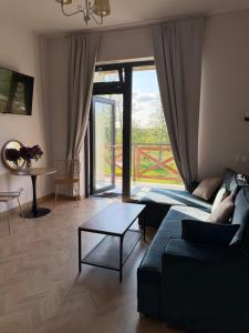 a living room with a couch and a table at Apartamenty u Gruzina in Ruda