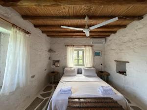 a bedroom with a large bed in a stone wall at 3 Bd Stonehouse with Swimming Pool in Paraspóri +86 photos