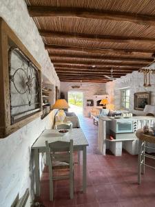 a living room with a table and a kitchen at 3 Bd Stonehouse with Swimming Pool in Paraspóri